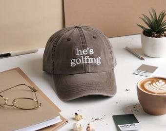 Embroidered He's Golfing Cap, Golf Wife Baseball Cap, Golfer girlfriend hat, Classic Dad Cap, Trendy simple humor hat, Funny Gift for Wife