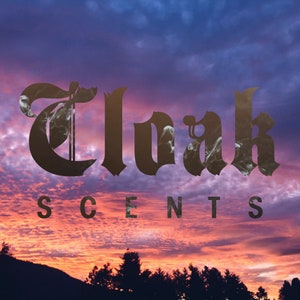 May include: A sunset sky with a dark brown logo that says "Cloak Scents" in a gothic font.
