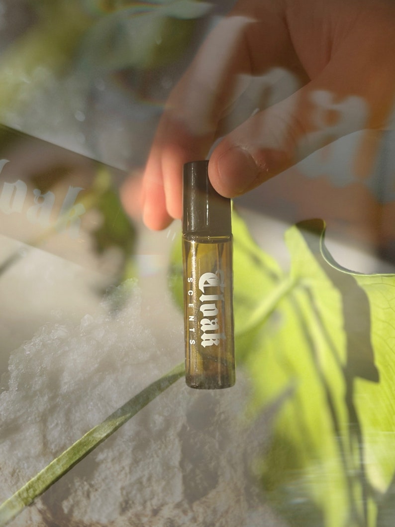 May include: A brown glass bottle with a black cap and the text "Cloak Scents" printed on the label.