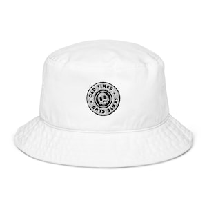 May include: White bucket hat with a black and white embroidered logo that says "Old Timer Skate Club" with a skull inside the circle.