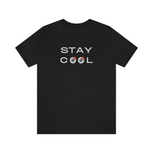 May include: Black t-shirt with the text "STAY COOL" in white lettering. Two brake rotors are incorporated into the word "COOL".