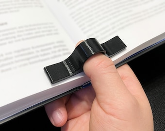 One-handed book holder for the thumb