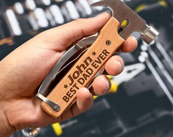 May include: A personalized wooden multi-tool with a hammer head, a knife, and a bottle opener. The tool is engraved with the text "John Best Dad Ever".