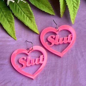 Heart Statement Earrings – Neon Pink “Slut” Slogan Dangles
