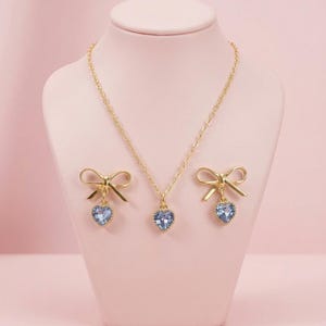 Gold Plated Bow Earrings and Necklace Set: Light Blue Heart Crystal