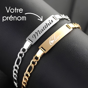 Peut inclure: Deux bracelets personnalisés avec des maillons de chaîne. Un bracelet est argenté avec le nom "Matthis" gravé sur l'étiquette. L'autre bracelet est doré avec le nom "Clara" et un cœur gravé sur l'étiquette.