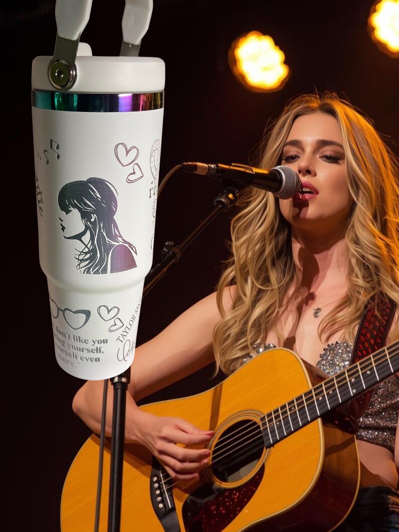 May include: White insulated tumbler with a handle, featuring a silhouette of a woman, musical notes, hearts, and the text "don't like you, love yourself, even more." The tumbler has a silver rim and a holographic band.