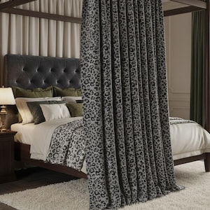 May include: A bedroom with a dark wood four-poster bed and a buttoned headboard. The bed has pillows and a leopard print blanket. Leopard print curtains hang in front of the bed. A cream-colored rug covers the floor, creating a luxurious atmosphere.