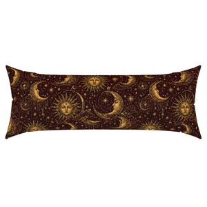 May include: A rectangular body pillow featuring a dark brown background with a repeating pattern of golden suns and crescent moons with faces, interspersed with small stars and celestial elements across the entire surface of the fabric.