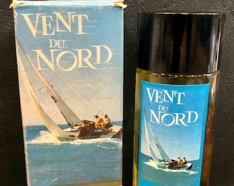 May include: A blue and white box with a sailboat image and the text "Vent du Nord Eau de Toilette pour Homme Plassard Parfumeurs Depuis 1815". A blue and white bottle with a sailboat image and the text "Vent du Nord Eau de Toilette pour Homme Plassard" is next to the box.