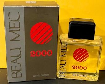 May include: A gray box with the text "BEAU MEC 2000" and a red circle with lines. The box is next to a clear glass bottle with the same text and design. The bottle is labeled "eau de cologne".