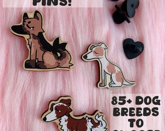 May include: Wooden dog pins in various breeds, including a German Shepherd, a Greyhound, and a Border Collie. The pins are brown, tan, and white, with black pin backs. Text reads "WOODEN DOG PINS!" and "85+ DOG BREEDS TO CHOOSE FROM."