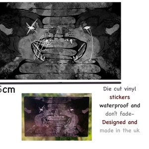 May include: Black and white die-cut vinyl sticker of two snarling wolf-like creatures with white markings. The sticker is 5 cm wide and says "Die cut vinyl stickers waterproof and don't fade- Designed and made in the uk".