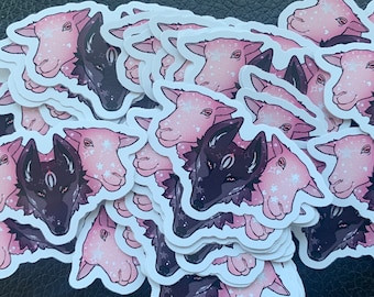 May include: A stack of pink and black stickers featuring a wolf and a sheep. The stickers have a starry sky design and are perfect for adding a whimsical touch to your belongings.
