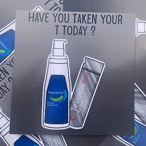 May include: A silver sticker with the text "HAVE YOU TAKEN YOUR T TODAY?" and illustrations of two testosterone products: a blue bottle labelled "Testosterone 16.2 mg/g Testosterone gel" and a silver tube labelled "Testosterone 40.5MG".