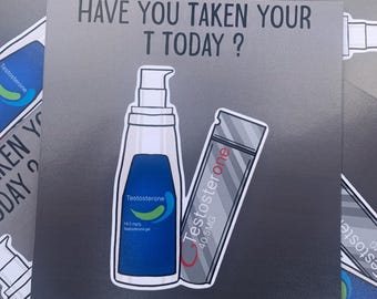 May include: A silver sticker with the text "HAVE YOU TAKEN YOUR T TODAY?" and illustrations of two testosterone products: a blue bottle labeled "Testosterone 16.2 mg/g Testosterone gel" and a silver tube labeled "Testosterone 40.5MG".
