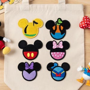 May include: A set of three ceramic mugs with a speckled, matte finish. The mugs are in shades of cream, light grey, and dark grey. Each mug has a simple, minimalist design, ideal for coffee or tea.