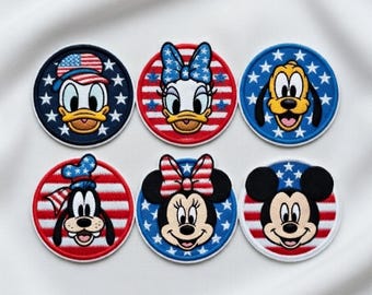 May include: Set of six round embroidered patches featuring Disney characters Donald Duck, Daisy Duck, Pluto, Goofy, Minnie Mouse, and Mickey Mouse. Each patch has a patriotic theme with red, white, and blue colors, stars, and stripes.