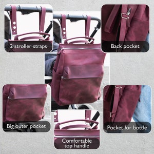 May include: Burgundy leather diaper bag with multiple pockets, including a large outer pocket, a back pocket, and a pocket for a bottle. The bag has two stroller straps, a comfortable top handle, and a zipper closure.
