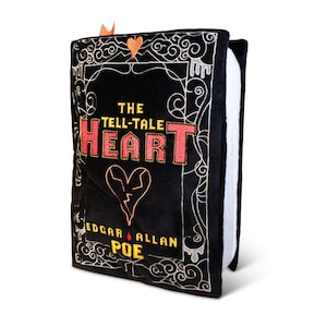 May include: A black plush book pillow with gold embroidery. The front cover features the title "The Tell-Tale Heart" by Edgar Allan Poe, with a broken heart graphic.