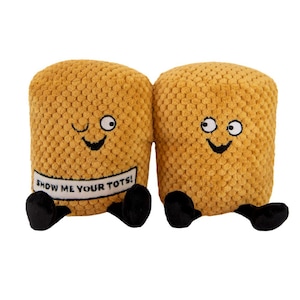 May include: Two plush brown tater tot toys with smiling faces. The tater tot on the left has a winking eye and a sign that says "Show me your tots!"