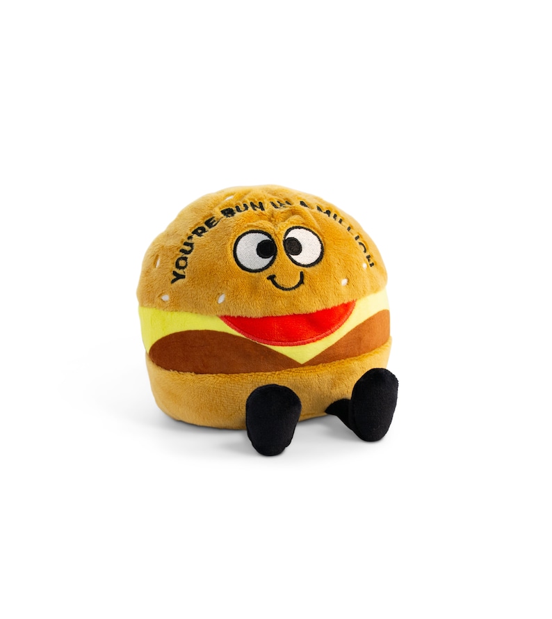 May include: A plush toy shaped like a hamburger with a smiling face and the text "You're bun in a million".