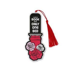 May include: A white bookmark with a red tassel features a bed design and the text "I LOVE A BOOK WITH ONLY ONE BED." The bookmark is decorated with pink and white roses.