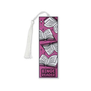 May include: A pink bookmark with a white tassel. The bookmark features open books and stars, with the words "Binge Reader" in a bubble font. The design is black and white.