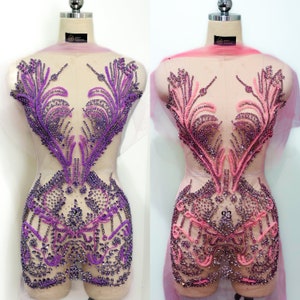 May include: Two sheer fabric bodices with intricate beaded designs. One bodice is purple and the other is pink.