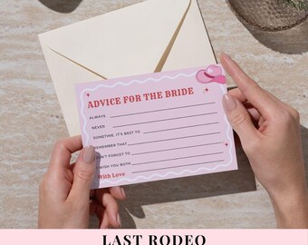 May include: A pink "Advice for the Bride" card featuring a cowboy hat illustration, held by hands. The card has lines for advice and the text "Last Rodeo Advice for the Bride Card" at the bottom. An envelope is in the background.