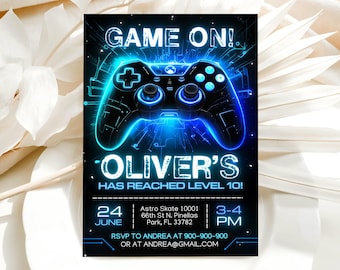 May include: A rectangular invitation card featuring a black background with a glowing blue video game controller graphic. The text reads: GAME ON! OLIVER'S HAS REACHED LEVEL 10! 24 JUNE, Astro Skate 10001 66th St N. Pinellas Park, FL 33782, 3-4 PM, RSVP TO ANDREA AT 900-900-900 OR AT ANDREA@GMAIL.COM.
