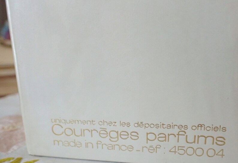 May include: White box with gold lettering that reads "uniquement chez les d&eacute;positaires officiels Courr&egrave;ges parfums made in france - ref: 4500 04"