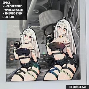 May include: Two holographic vinyl stickers featuring a white-haired anime character with elf ears wearing a black crop top, black shorts, and green and black leg straps. The stickers are die-cut and have a 3D embossed effect. The text "DEMONSEKA" is visible at the bottom of the image.