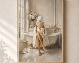 May include: A framed wall art print depicting a person in a white bathrobe and towel wrap sitting on a white clawfoot bathtub with gold feet. The person is reading a book. A small gold side table with a glass of champagne sits nearby.