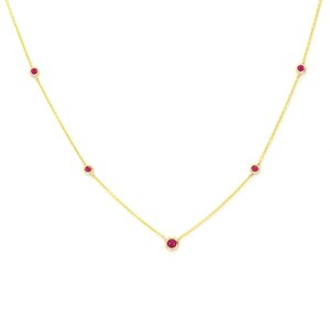 May include: A delicate gold chain necklace with five small red gemstones.