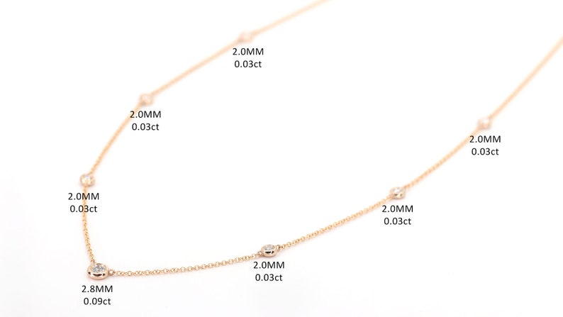 May include: A delicate rose gold necklace with several small, round diamonds evenly spaced along the chain. The diamonds are 2.0mm and 2.8mm in size. Text indicates the carat weight of each diamond.