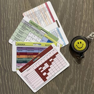 May include: A set of laminated cards with information about blood types, blood gas interpretation, and blood draw order of draw. The cards are color-coded and have a hole punched in the top corner for a lanyard.