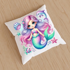 May include: White square pillow featuring a colorful illustration of a mermaid with long pink and purple hair, a teal tail, and a pink seashell bra. A dolphin, starfish, and fish are also depicted.