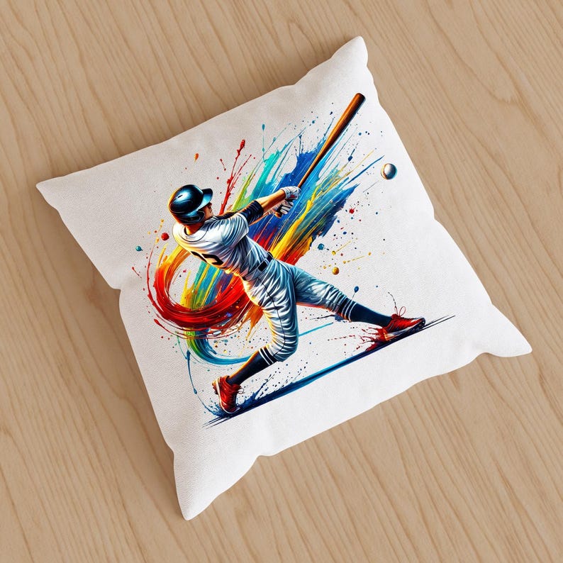 May include: A white pillow with a colorful abstract design featuring a baseball player swinging a bat. The design includes splashes of red, orange, yellow, green, and blue paint.