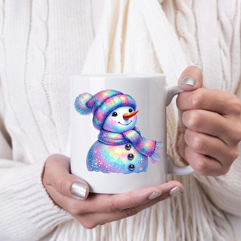 May include: White ceramic mug featuring a colourful snowman design. The snowman is wearing a blue and purple hat with a white pom-pom and a matching scarf. The snowman has a carrot nose and a happy expression.
