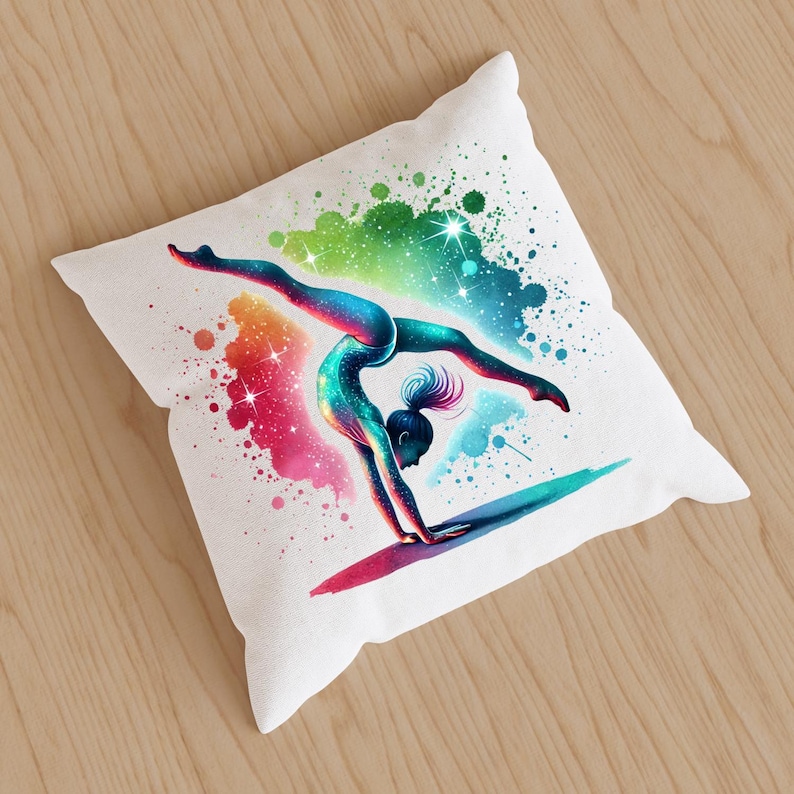 May include: A white cushion featuring a colourful illustration of a gymnast performing a handstand. The background is a watercolour-style design with splashes of pink, blue, green, and yellow.