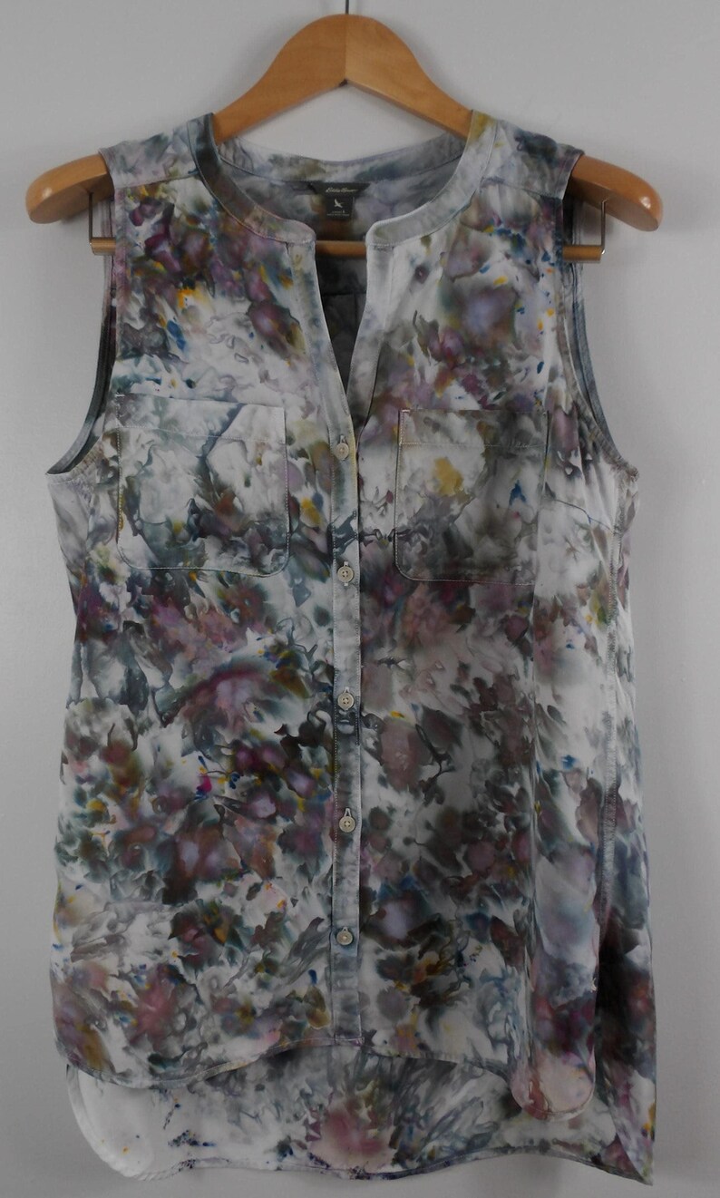 May include: A white ceramic mug with a black handle and the text "But First, Coffee" in a handwritten style. The mug is likely for hot beverages and has a glossy finish.