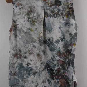 May include: A white ceramic mug with a black handle and the text "But First, Coffee" in a handwritten style. The mug is on a white surface. The mug is 4 inches tall.