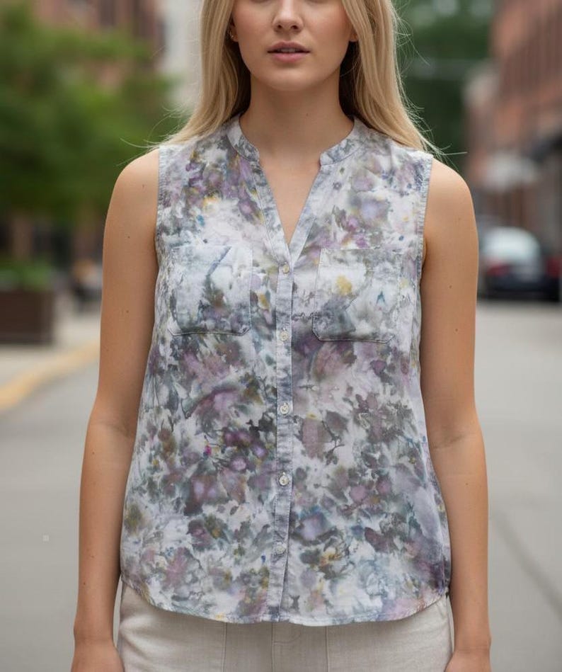 May include: A white ceramic mug with a colorful floral design. The mug features a handle and a wide rim. The flowers are in shades of pink, purple, and yellow. The mug is likely for beverages.