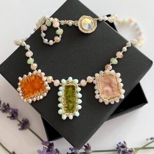 Crochet glass beads necklace is crocheted by hand  with gold thread, small glass beads and embelished with velvet handmade charms. 
It is fastened with crystal button.
Length of necklace is 20,07 inches/51 cm.