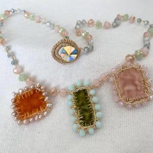 The edge of orange square charm is beaded with mini freshwater pearls. The edge green rectangle charm is beaded with bluish glass beads. The edge of cream charm is beaded with pastel rose glass beads.