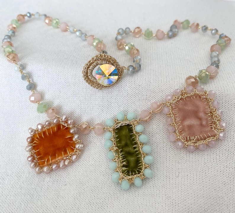 The edge of orange square charm is beaded with mini freshwater pearls. The edge green rectangle charm is beaded with bluish glass beads. The edge of cream charm is beaded with pastel rose glass beads.
