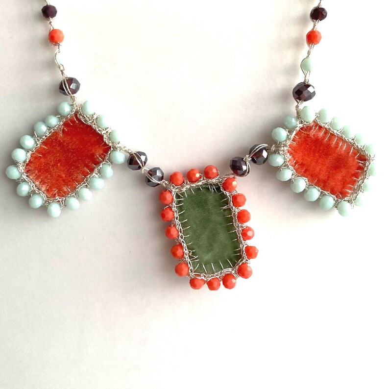 Orange and green velvet charms embroidered with mint and orange glass beads.