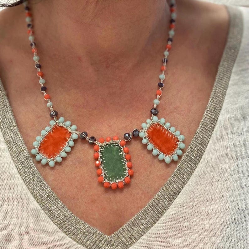 Summer necklace embellished with three handmade charms made of orange and green velvet.