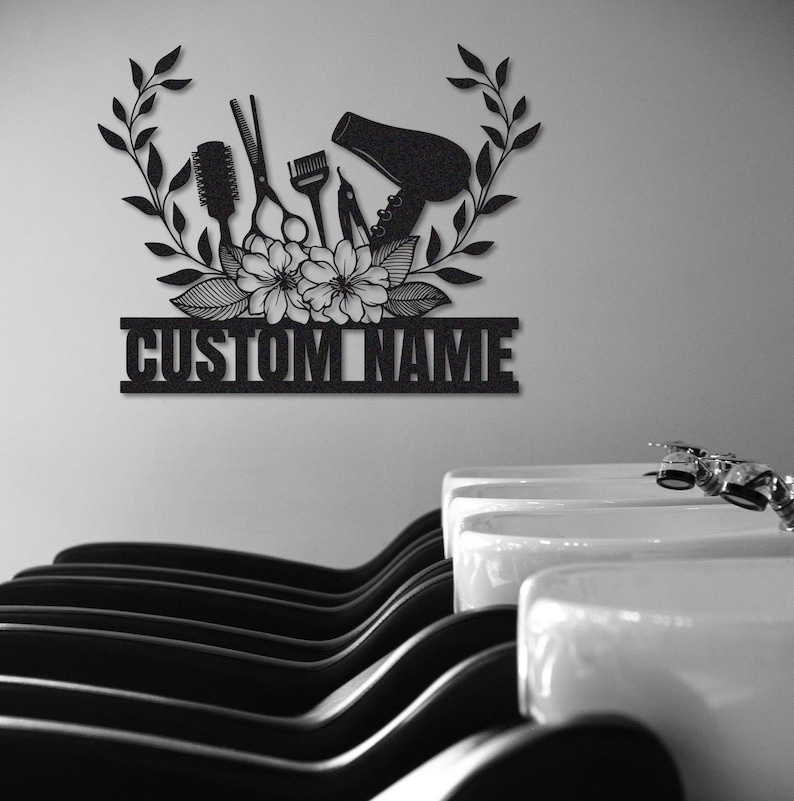 May include: Black metal silhouette of hairdressing tools, including scissors, combs, a hair dryer, and a bottle of hair dye, with floral accents and the text "CUSTOM NAME".